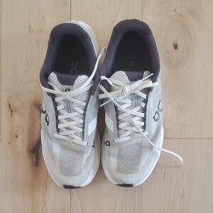 On Running White and Black Athletic Shoes